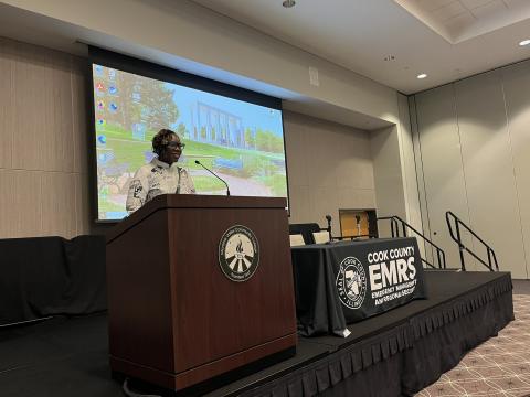 EMRS representative speaking at a podium at the 2024 Training and Preparedness Summit